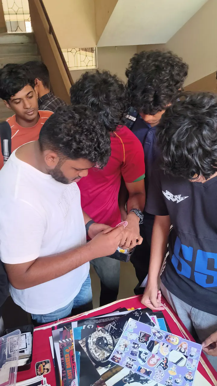 Students crowding a Stix N Vibes stall, picking stickers and posters