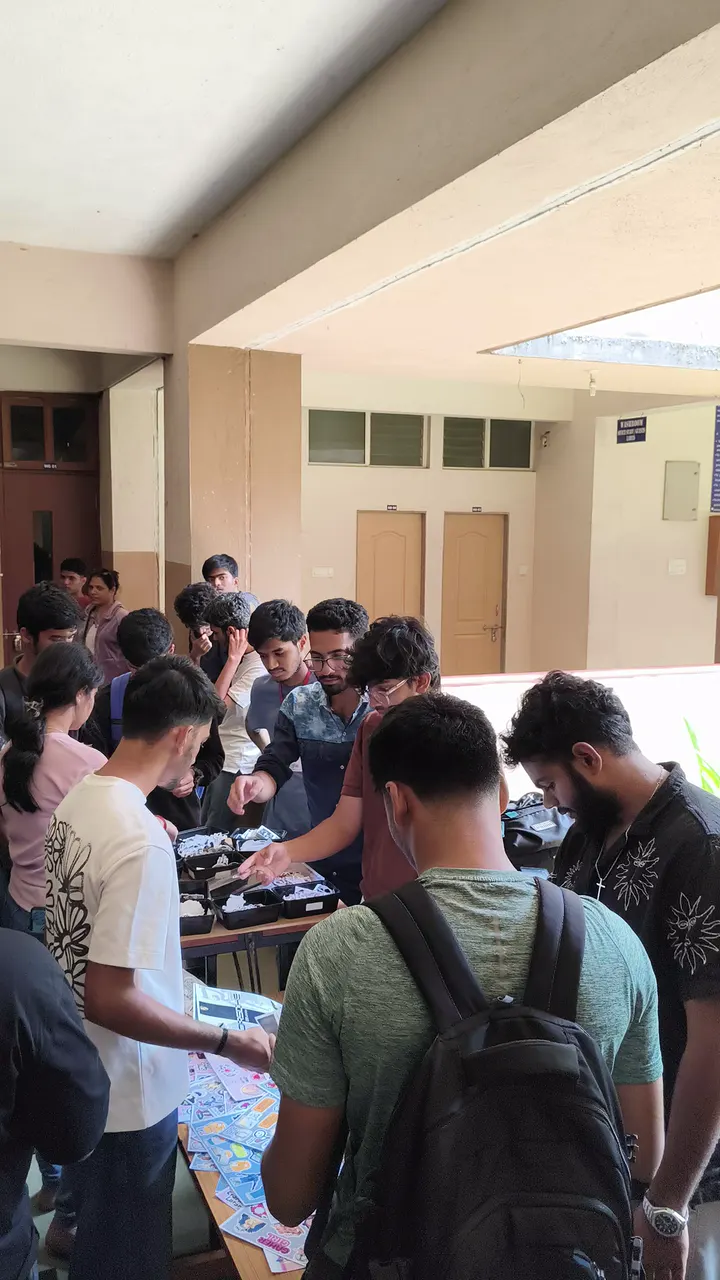 Students crowding a Stix N Vibes stall, picking stickers and posters
