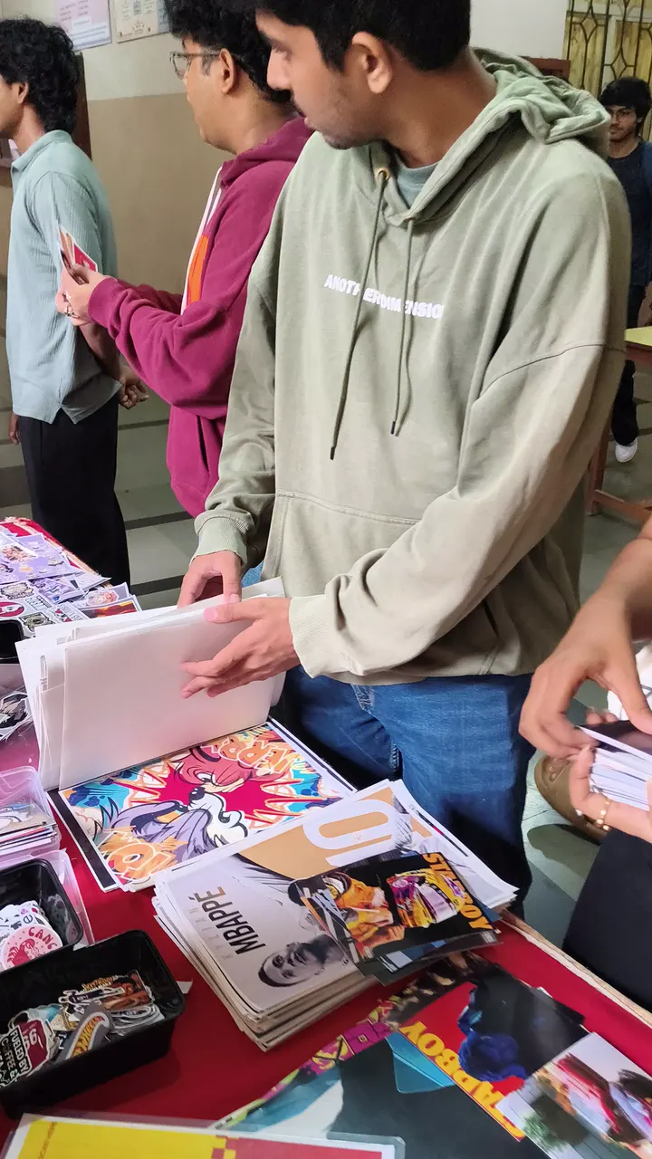 Students crowding a Stix N Vibes stall, picking stickers and posters